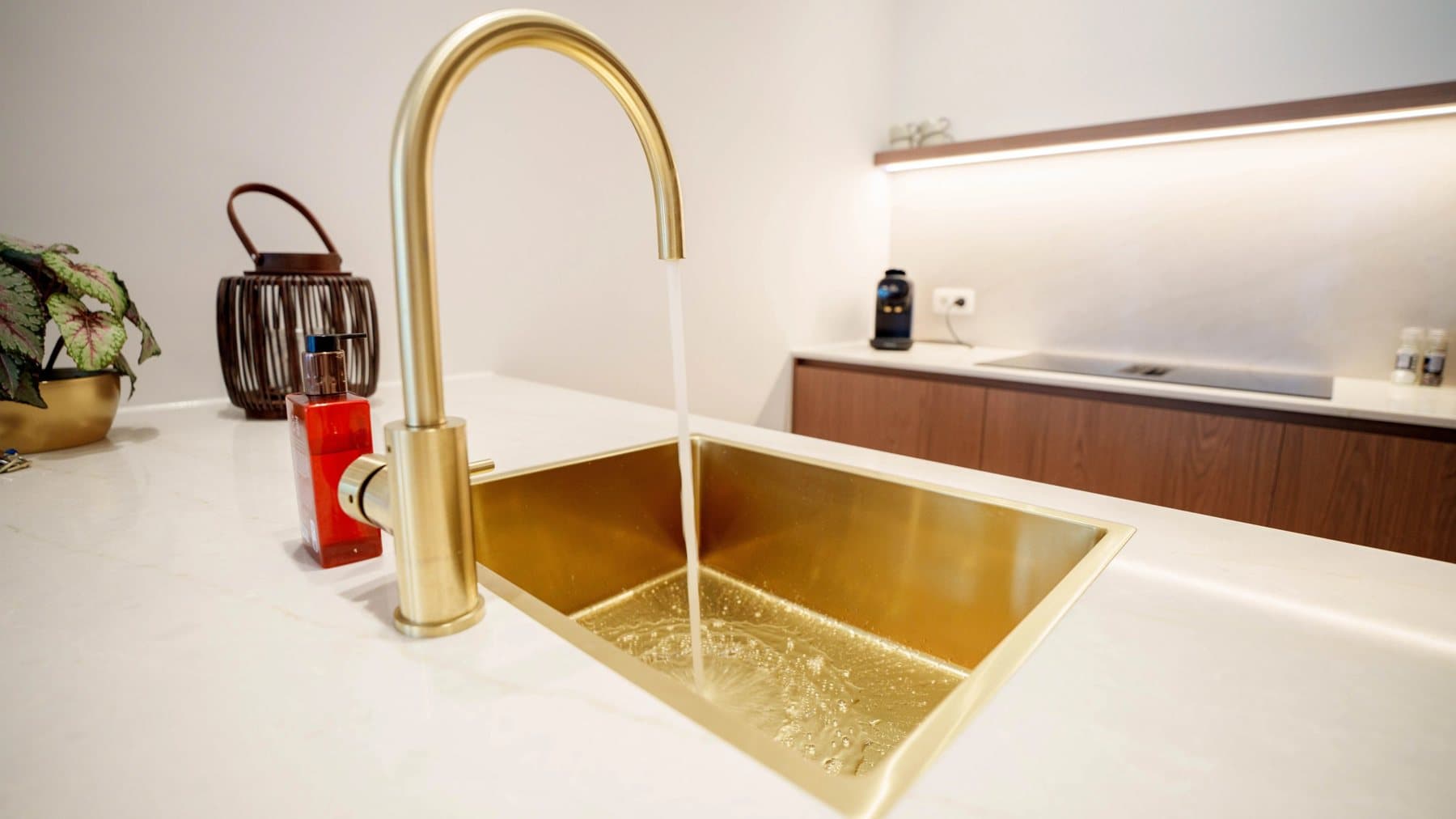 Gold kitchen tap and sink in a flat in Ostend