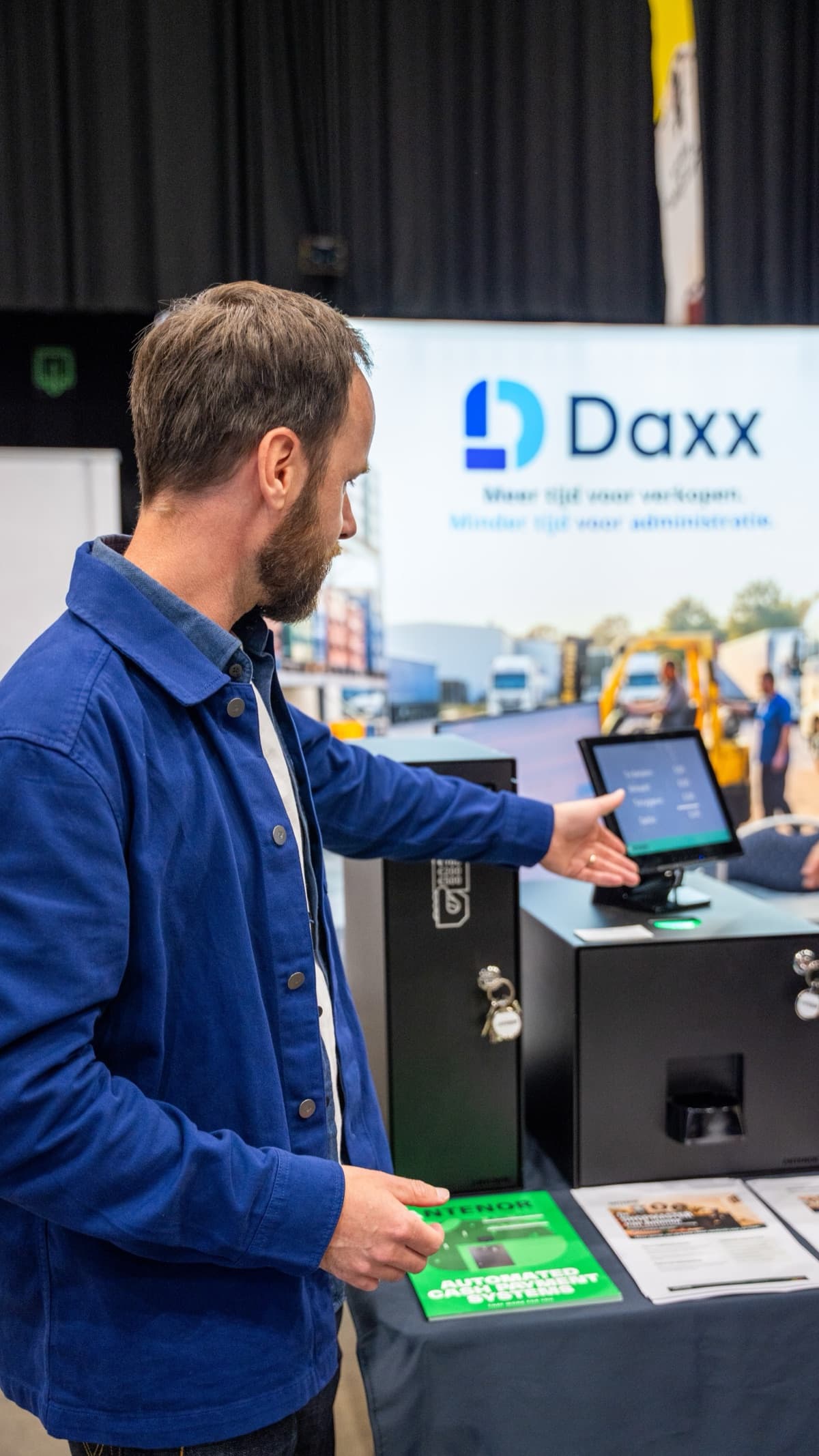 A team member shows the till with automatic cash handling