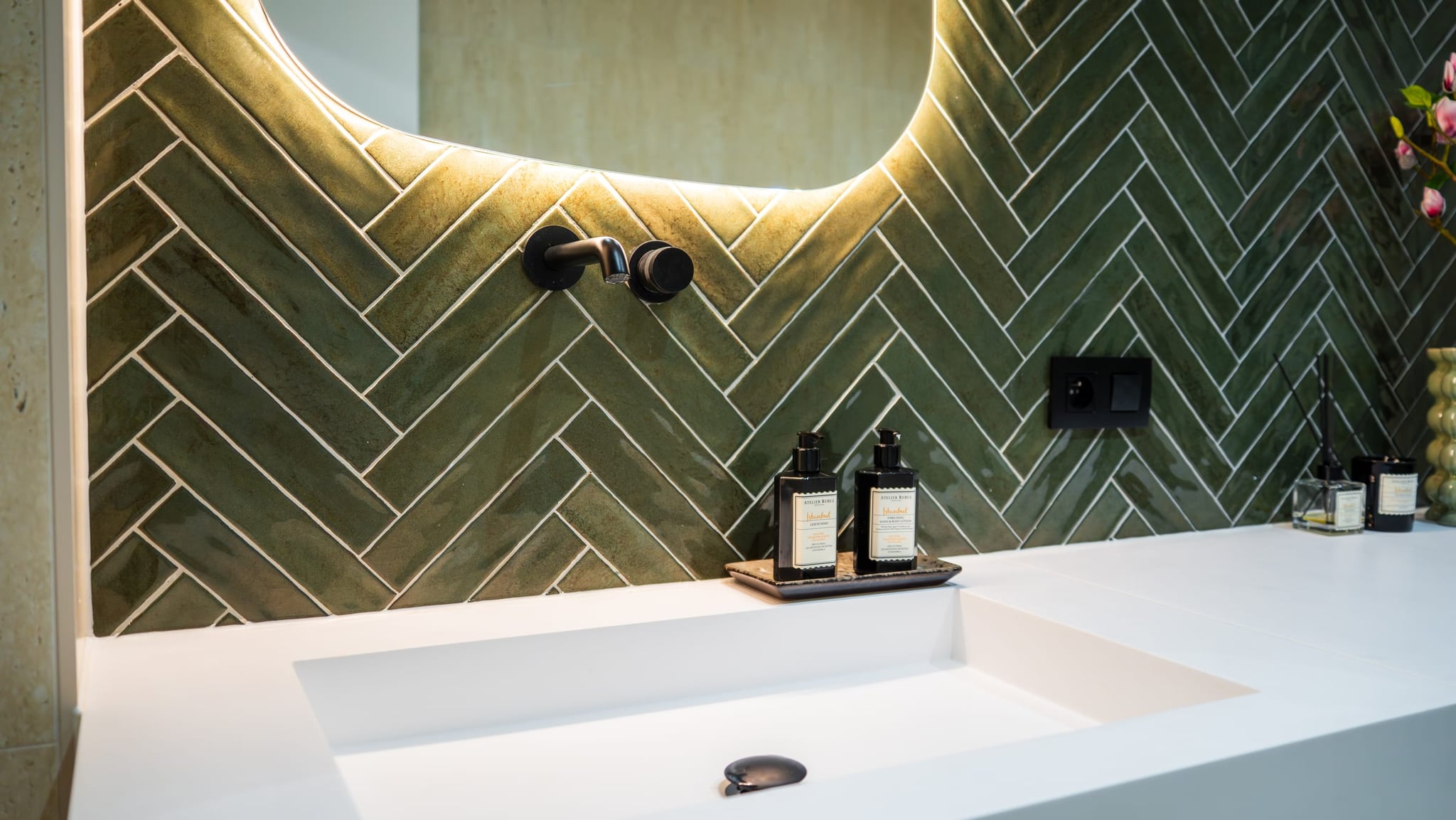 Bathroom design with warm natural stone tones supplied by Beva
